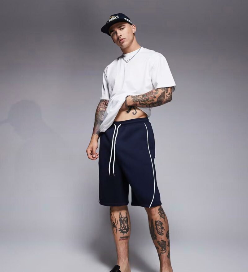 ASOS DESIGN oversized short with side piping in navy
